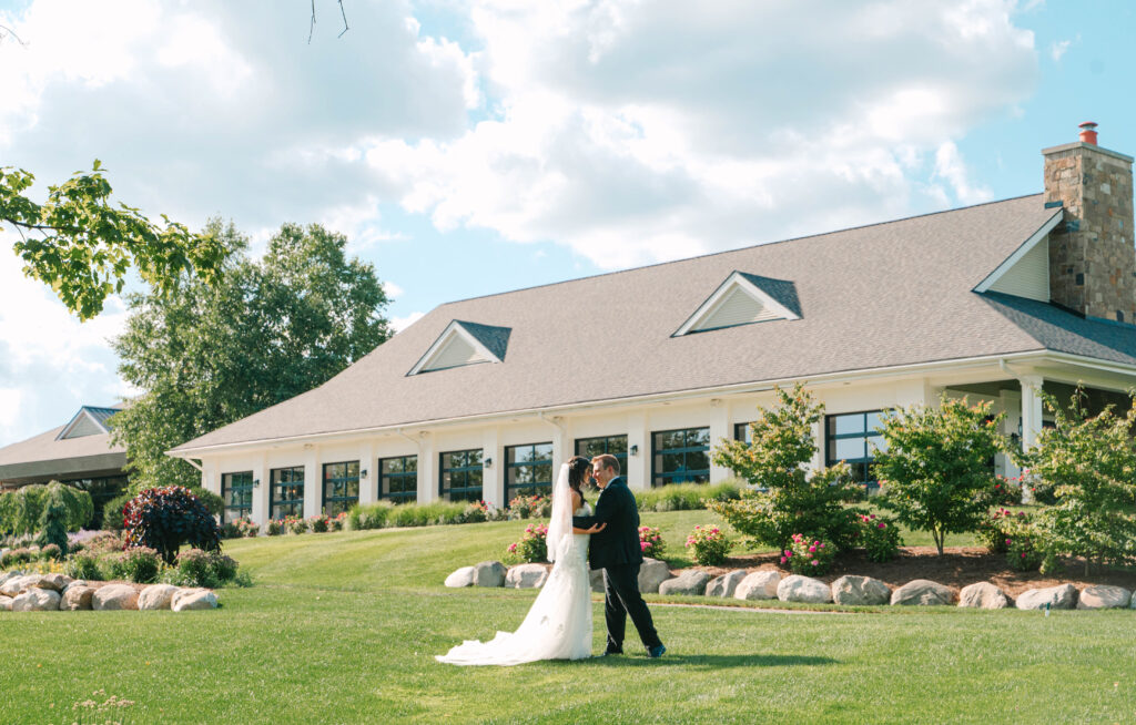 A bride and groom outside at the Union Pavilion at Railside in the back by Kelly Jo Photography
