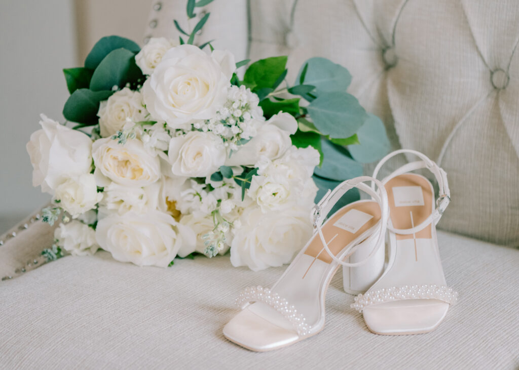 white bride shoes with pearls and white roses by a Grand Rapids wedding photographer