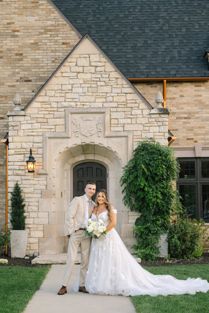 a bride and groom by the stone doorway at Venue3Two by Kelly Jo Photography