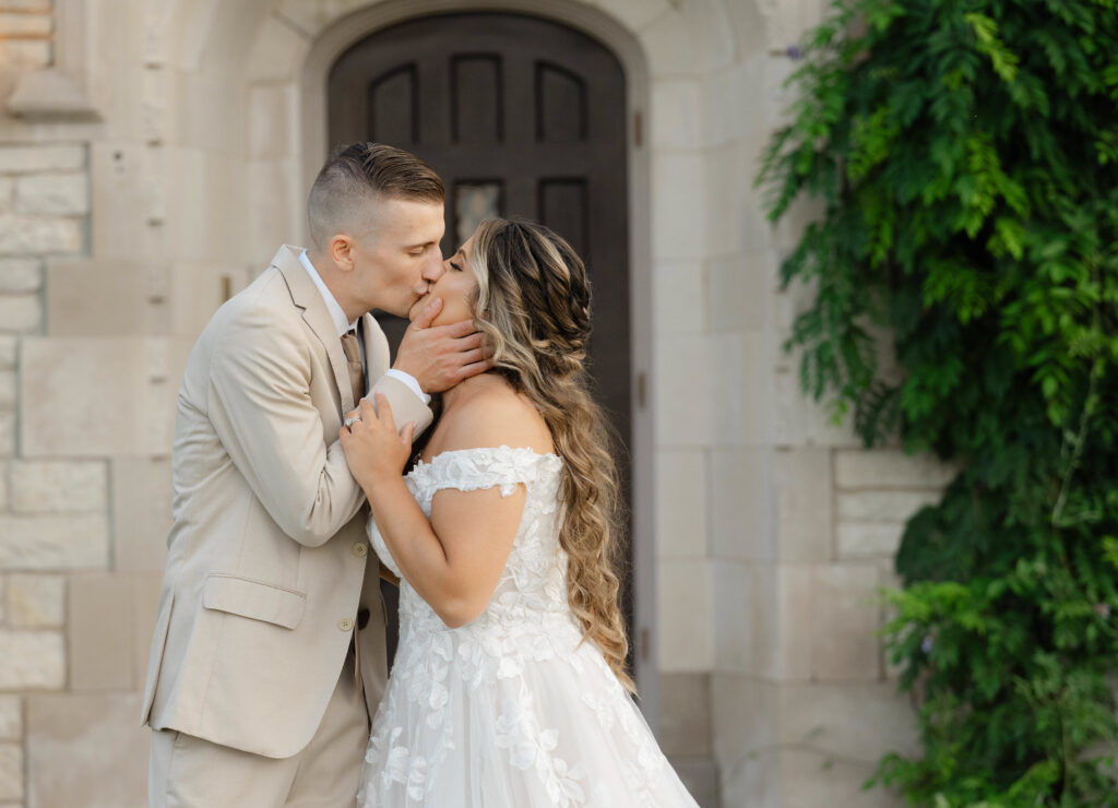a groom kisses his bride at Venue3Two