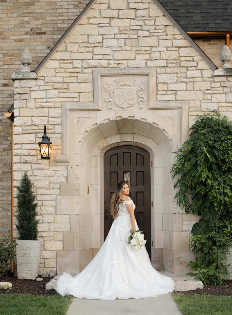 The bride by the front door at Venue3Two taken by a wedding photographer in Grand Rapids 