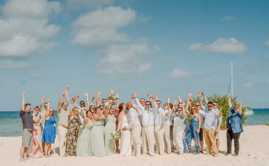A wedding group cheers for a bride and groom at their cruise wedding in Cozumel